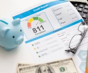 A printed credit report sits on a desk. It shows a good credit score of 811 underneath a 